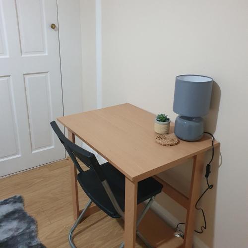 a desk with a speaker on top of it at Comfy bedroom D in London