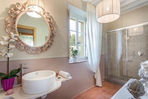 a bathroom with a sink and a mirror at Villa Principessa Elisa, Amazing Views, Spa & Private Pool in Capannori