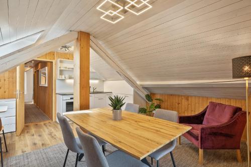 a dining room with a wooden table and chairs at Hotel Krone by b-smart in Bad Ragaz
