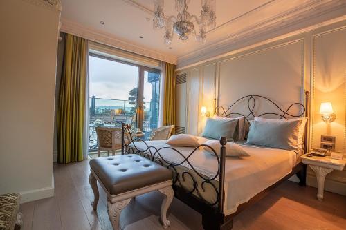 a bedroom with a bed and a large window at MFB Tarabya Hotel in Istanbul