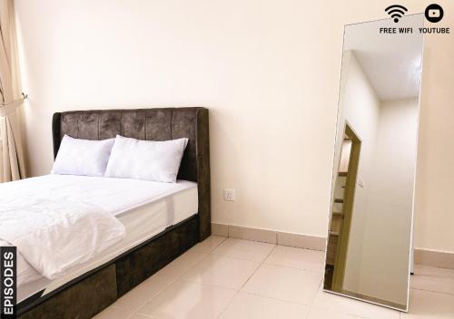 Schlafzimmer mit einem Bett und einem Spiegel in der Unterkunft Cozy 2 Rooms Nilai Free Wifi 03 in Nilai