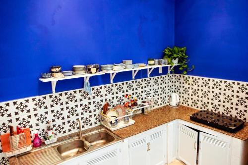 uma cozinha com um lavatório e uma parede azul em Peaceful house em Vung Tau
