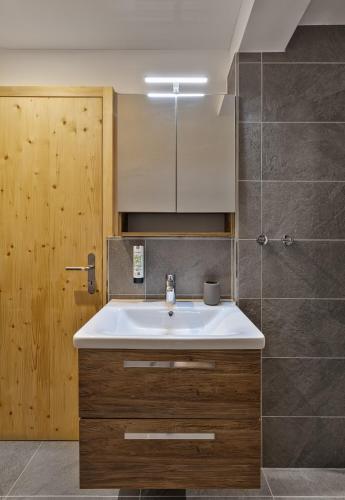 a bathroom with a white sink and a shower at Hotel Krone by b-smart in Bad Ragaz
