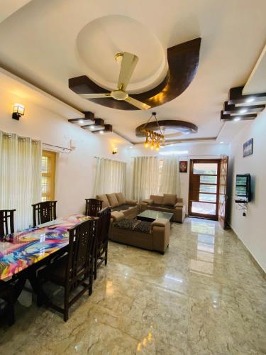 - un salon avec un ventilateur de plafond et un canapé dans l'établissement Maldevta Homestay, à Dehradun
