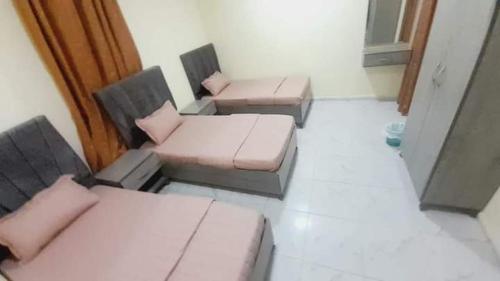 a room with two beds and two chairs at Jordan home in Irbid