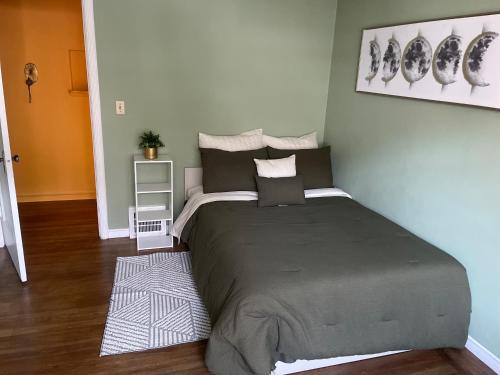 a bedroom with a large bed in a room at H.U.S.H (Happy Your Staying Here!). Short Term Rental in Oakland