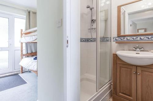 a bathroom with a sink and a shower at 36 Beach Court - 1 Bed Apartment - Saundersfoot in Saundersfoot