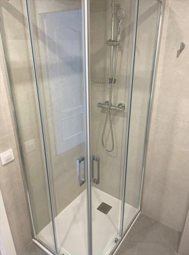 a shower with a glass door in a bathroom at Estudio al lado de la playa in Calafell