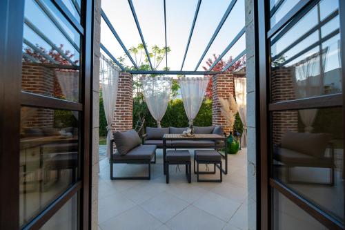 a patio with a couch and a table and chairs at House "Mediterrian spirit" with jacuzzi in Zadar in Zadar