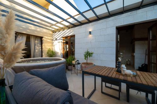 a living room with a couch and a tub at House "Mediterrian spirit" with jacuzzi in Zadar in Zadar
