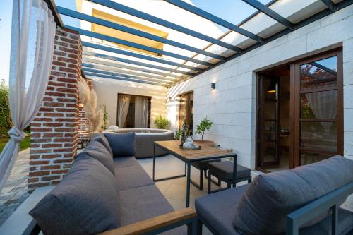 a patio with a couch and a table at House "Mediterrian spirit" with jacuzzi in Zadar in Zadar
