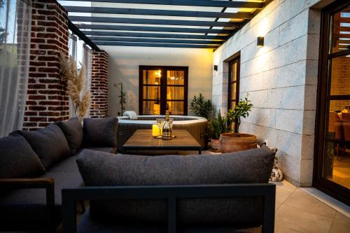 a patio with a couch and a table at House "Mediterrian spirit" with jacuzzi in Zadar in Zadar