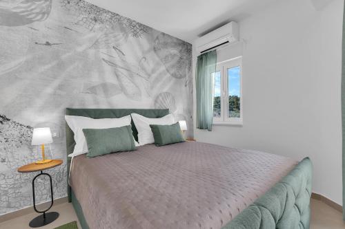 a bedroom with a large bed with a wall at Luxury Apartment Nugal- heated pool in Makarska