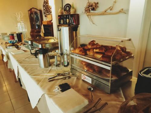 a counter with several trays of food in a kitchen at Casa Oliva borgo del Benessere Olistico in Bargni