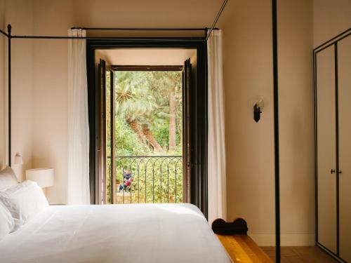 a bedroom with a bed and a large window at Portella in Palma de Mallorca