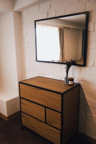 a dresser with a mirror on top of it at Seaside Apartments Roja in Roja
