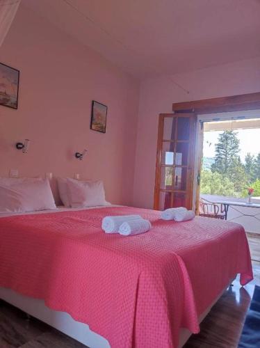 a bedroom with a bed with two towels on it at Marianna House in Agios Georgios Pagon