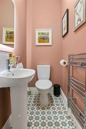 a bathroom with a white toilet and a sink at Hestia House in Derry Londonderry