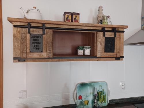 a wooden shelf on a wall with a bowl at La casa del gatico in Lumbier