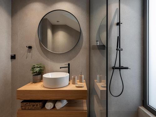 a bathroom with a sink and a mirror at Villa Zefyros With Sea View in Plataniás