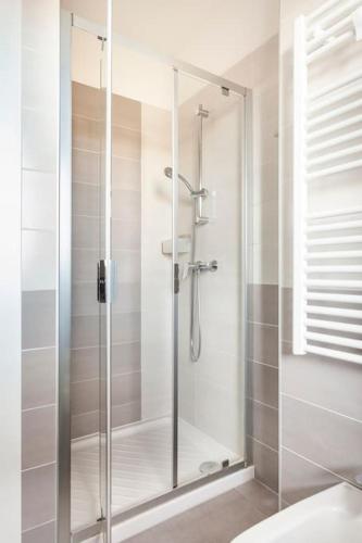 a shower with a glass door in a bathroom at casa MEV è un attico in centro a Fiume Veneto in Fiume Veneto