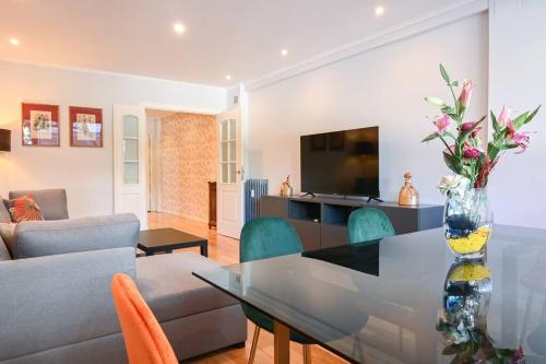 a living room with a table with a vase of flowers at For You Rentals Apartamento Espacioso de Tres Dormitorios en Madrid ORE51 in Madrid