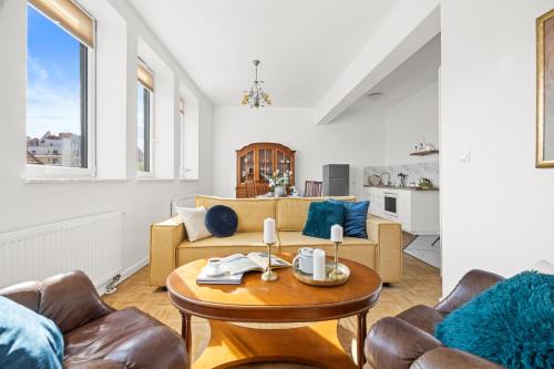 a living room with a couch and a table at Apartament Bursztynowy in Gdańsk