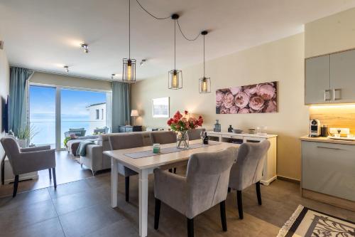 a kitchen and living room with a table and chairs at Lake Side Luxury Steps To The Lake Lela - Happy Rentals in Balatonlelle