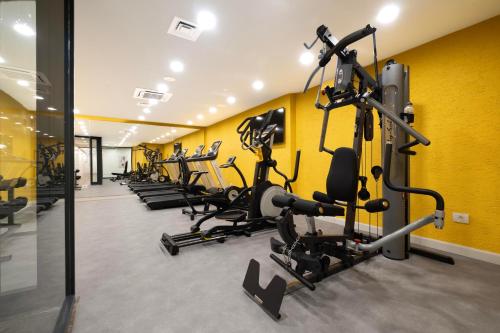 a gym with rows of tread machines in a yellow wall at New Inn Hotel Old Town in Istanbul