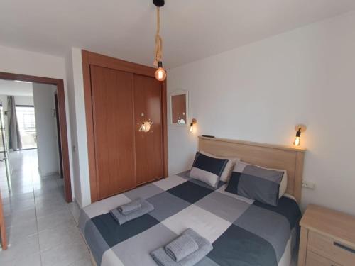 a bedroom with a large bed with two pillows at Apartmento START Complex Amaya Fuerteventura in Costa de Antigua
