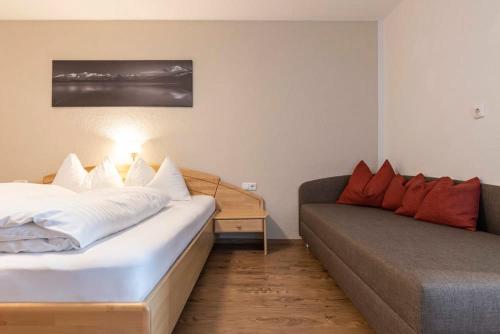 a living room with a bed and a couch at EDELWEISS Ladis in Ladis