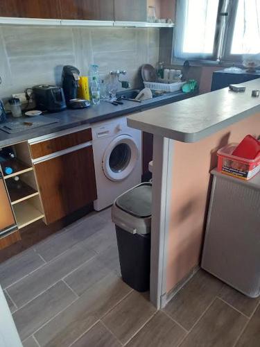 a kitchen with a sink and a washing machine at Argeles plage in Argelès-sur-Mer