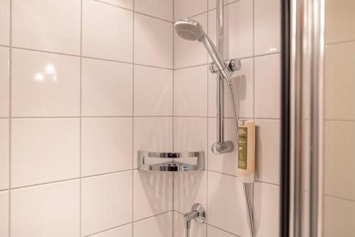 a shower with a shower head in a bathroom at EDELWEISS Ladis in Ladis