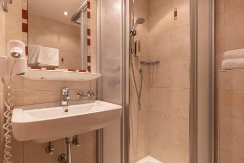 a bathroom with a sink and a shower at EDELWEISS Ladis in Ladis