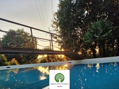 a sign on a bridge over a swimming pool at Quinta das Carbonças in Fafe