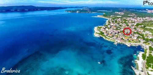 an island in the water with a red circle on it at Apartment Tomi in Brodarica