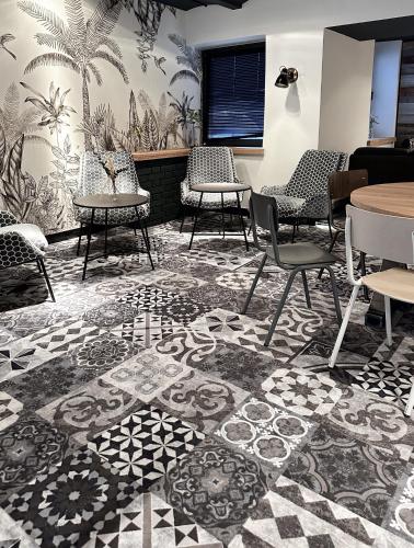 a waiting room with chairs and tables and a table at Hotel Berliner Hof by Coffee Fellows Hotels in Kiel