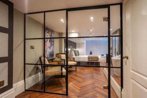 a room with glass walls and a bedroom at 34 Coney Street in York