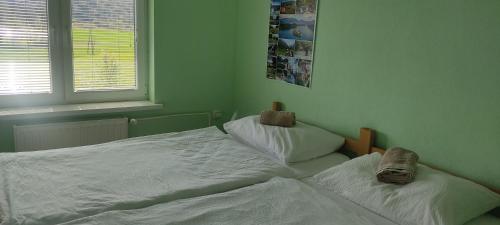 a bedroom with two twin beds and a window at Hacienda Bled Rooms in Bled