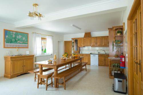 a kitchen with wooden cabinets and a wooden table at Refúgio de Alburitel in Alburitel