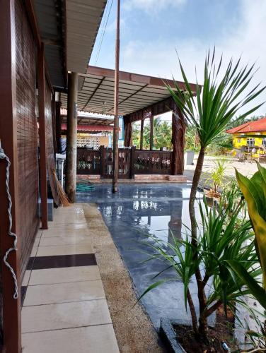 a swimming pool in the middle of a building at D'Maryam Homestay in Muar