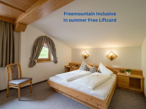 a bedroom with a large bed and a chair at Landhaus Casper in Gerlos