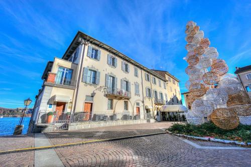a building with a sculpture in front of it at Aparthotel Arona - Happy Rentals in Arona