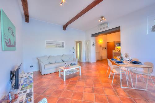 a living room with a couch and a table at Aparthotel Arona in Arona