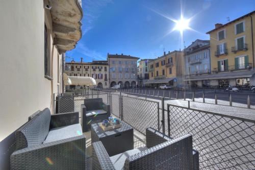 a balcony with chairs and a table on a city street at Aparthotel Arona in Arona