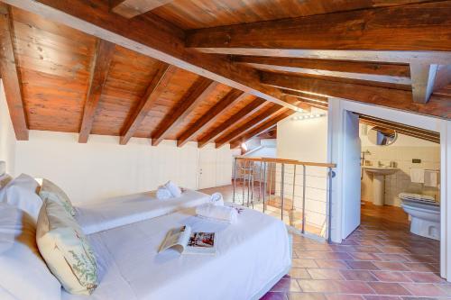 a bedroom with two beds in a room with wooden ceilings at Aparthotel Arona in Arona