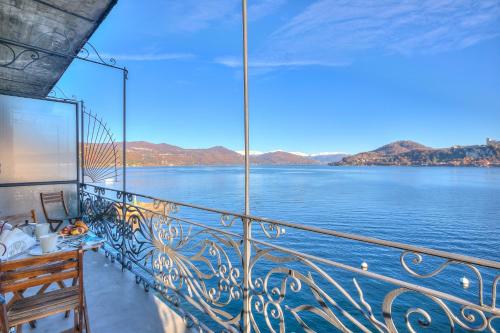 a balcony on a boat with a view of the water at Aparthotel Arona in Arona