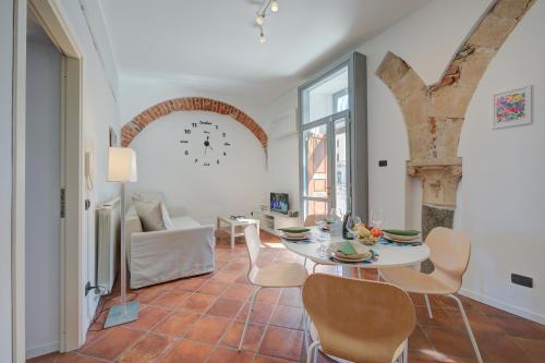 a living room with a table and chairs at Aparthotel Arona in Arona