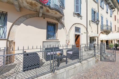 a building with a fence in front of a street at Aparthotel Arona in Arona