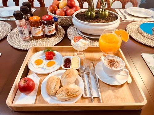 a table with a tray of breakfast food on it at Cosy Homes - 15 Minutes Away From Melbourne Airport in St Albans